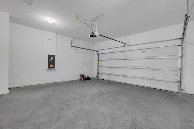 garage with a garage door opener and electric panel