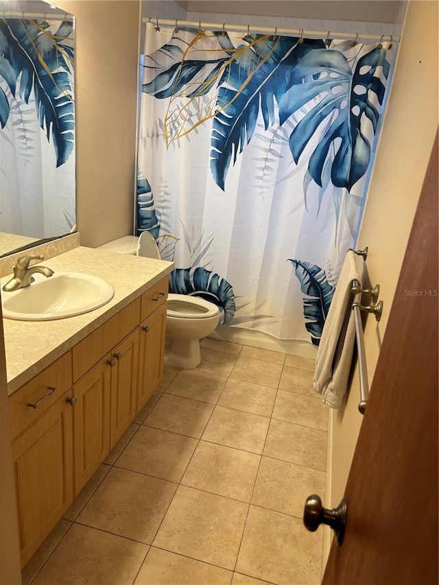 bathroom featuring tile patterned floors, vanity, and toilet