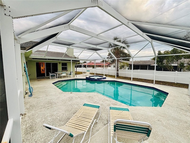 view of swimming pool with a lanai, an in ground hot tub, and a patio