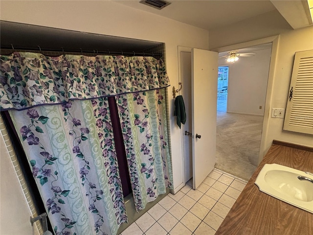 bathroom featuring ceiling fan, tile patterned floors, vanity, and shower / bath combination with curtain