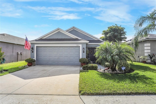 ranch-style house featuring a front lawn and a garage