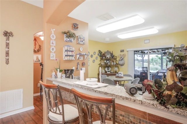 dining room with bar and dark hardwood / wood-style flooring