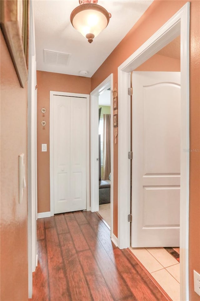 corridor with wood-type flooring