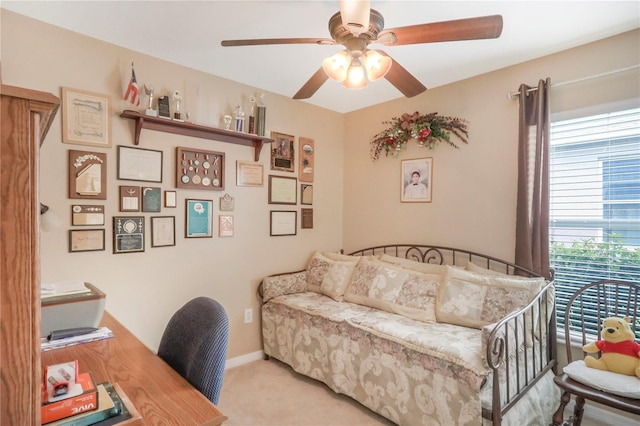 carpeted office space featuring ceiling fan