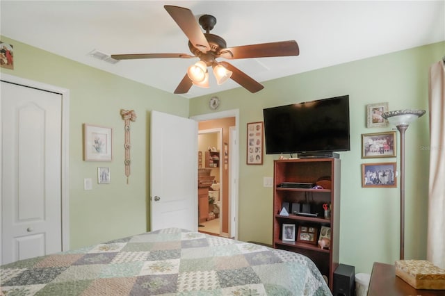 bedroom with ceiling fan and a closet