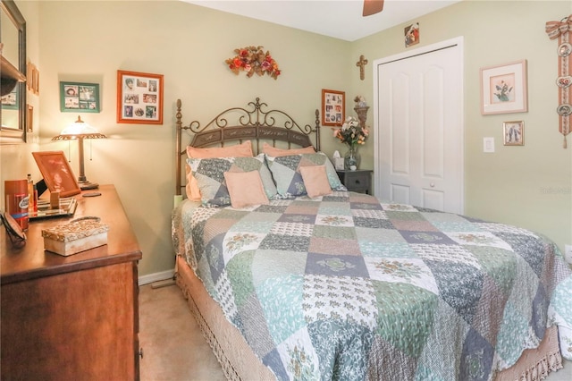 carpeted bedroom with ceiling fan and a closet