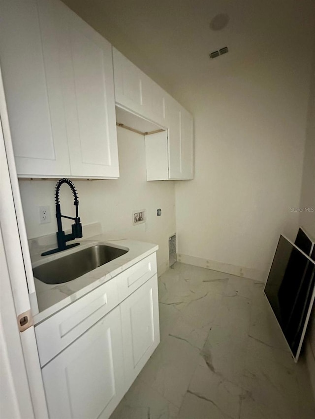 washroom featuring cabinets, sink, and washer hookup