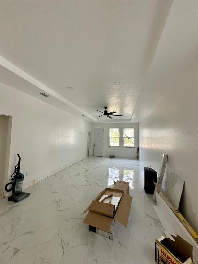 unfurnished living room featuring ceiling fan