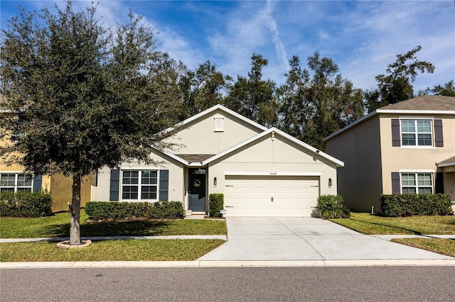 view of front facade with a front yard and a garage