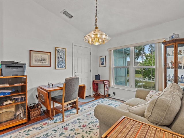 office area featuring lofted ceiling, a notable chandelier, and wood-type flooring