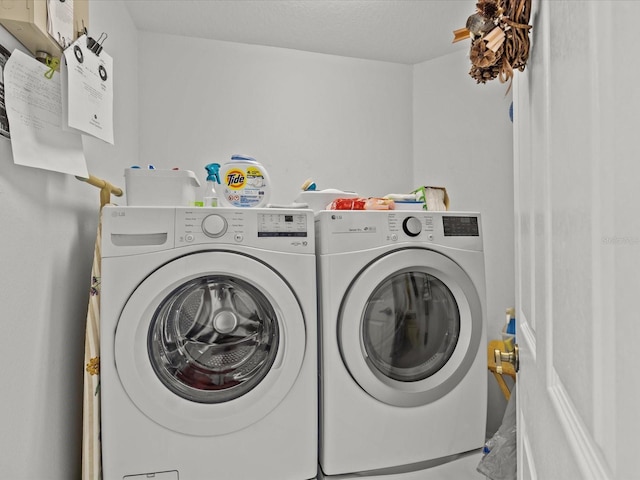 washroom featuring washer and clothes dryer