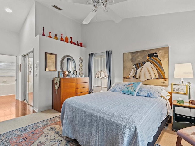 bedroom with a closet, ceiling fan, and ensuite bathroom