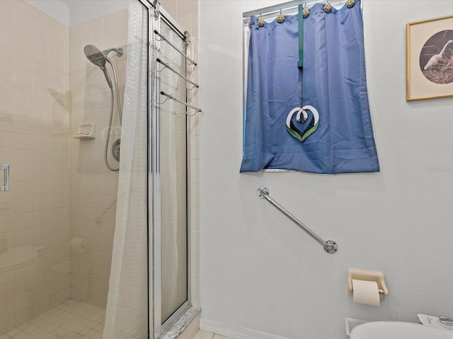 bathroom with toilet and a shower with shower curtain