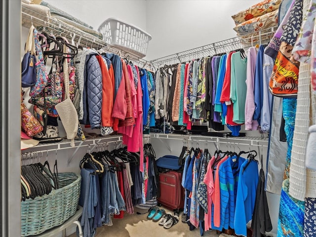 walk in closet featuring carpet