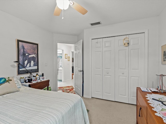 carpeted bedroom with a closet and ceiling fan