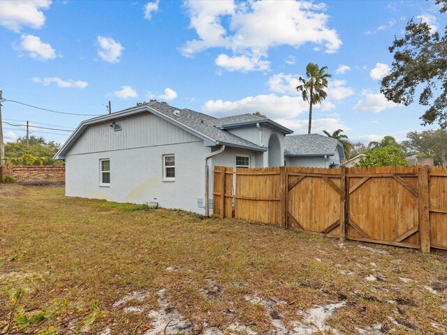 view of side of property with a yard