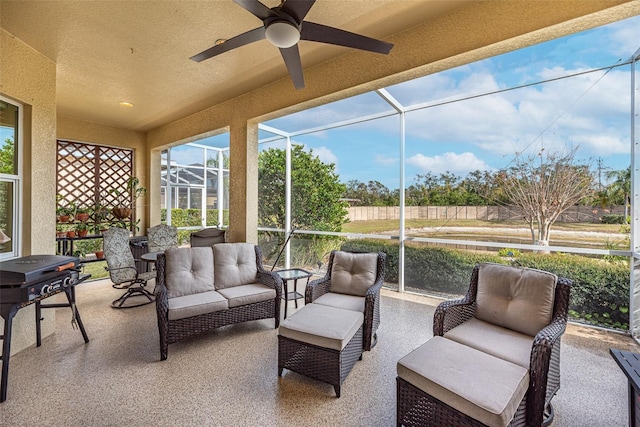 sunroom / solarium featuring ceiling fan