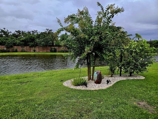 exterior space with a lawn and a water view