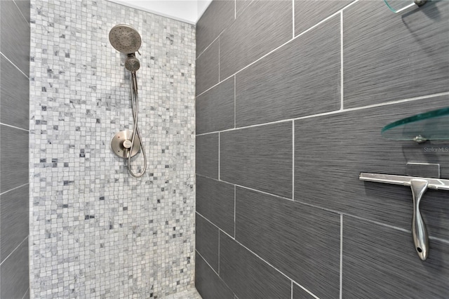 bathroom with tiled shower