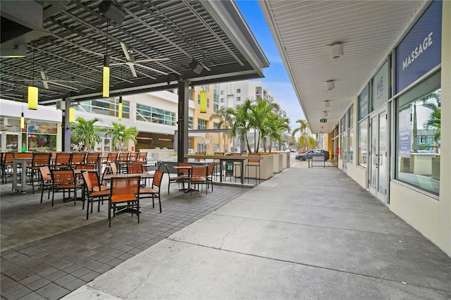 view of patio featuring ceiling fan and exterior bar