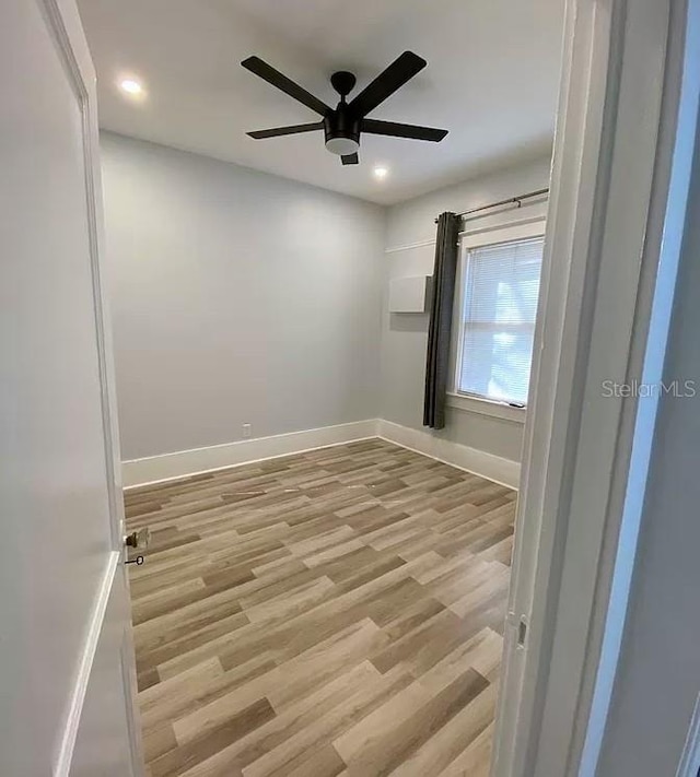 spare room with ceiling fan and light hardwood / wood-style floors