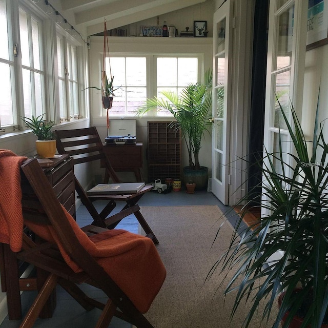 sunroom featuring vaulted ceiling