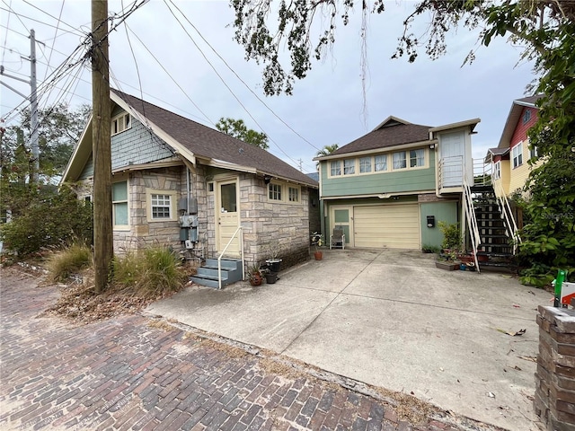 rear view of house with a garage