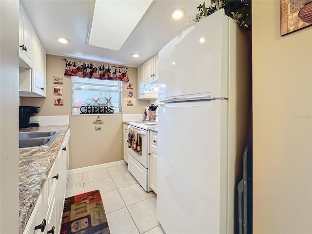 kitchen with light stone countertops, white appliances, white cabinets, sink, and light tile patterned floors