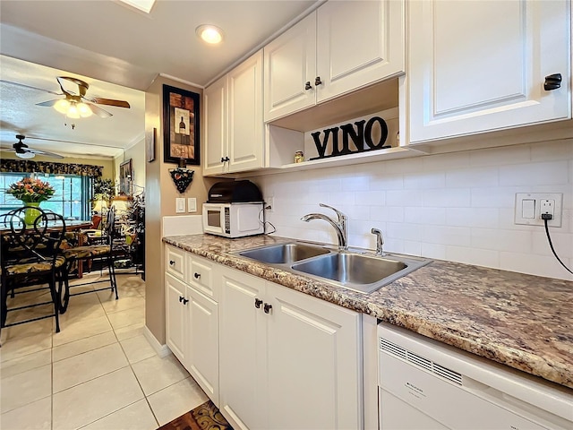 kitchen featuring sink, light tile patterned flooring, white appliances, and white cabinetry