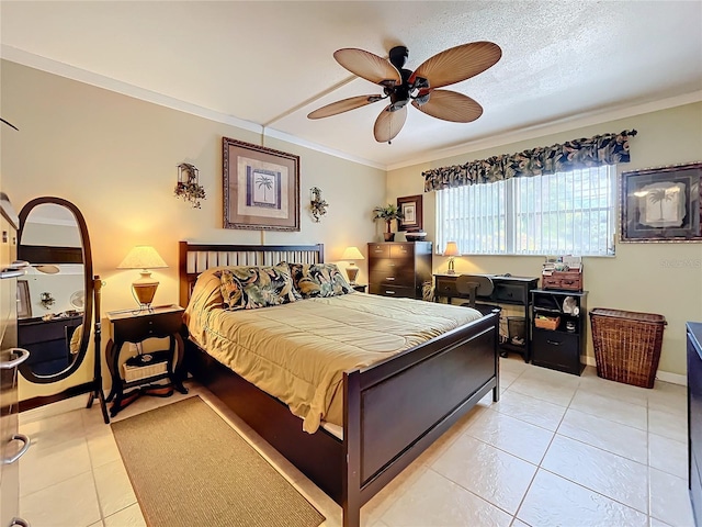 tiled bedroom featuring ceiling fan, a textured ceiling, and ornamental molding