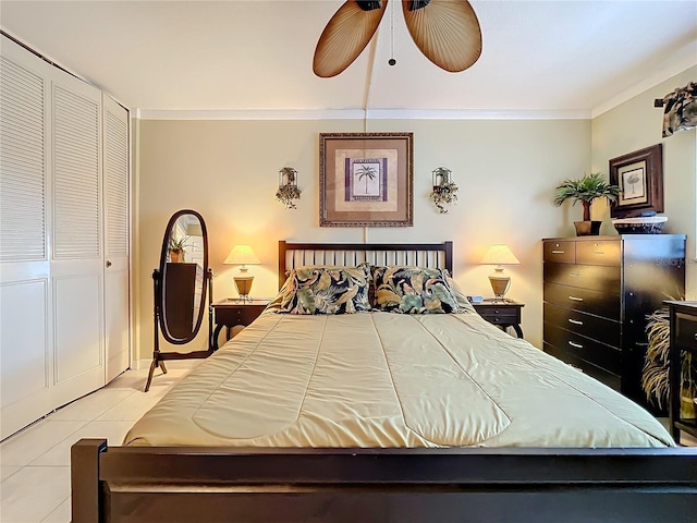 tiled bedroom featuring ceiling fan, a closet, and ornamental molding