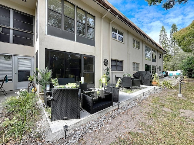 rear view of house featuring a patio area and an outdoor hangout area