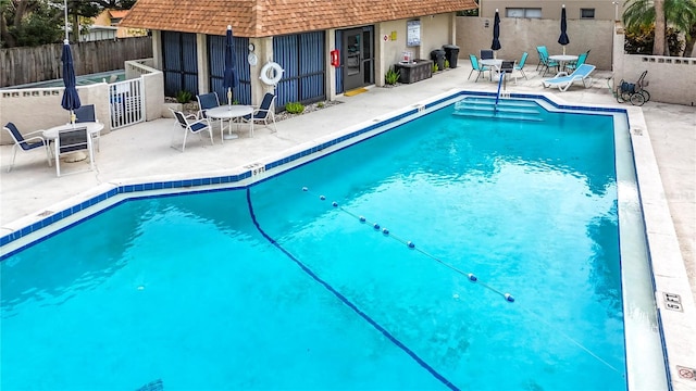 view of swimming pool with a patio area