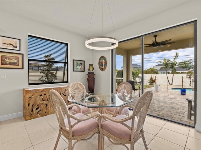 dining area with light tile patterned floors and ceiling fan