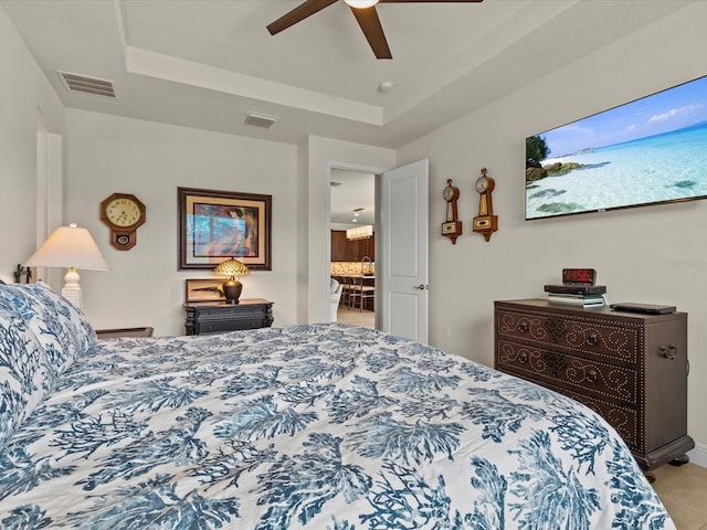 bedroom featuring a raised ceiling and ceiling fan