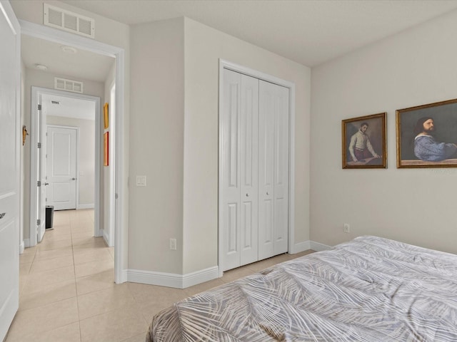 bedroom featuring a closet and light tile patterned flooring