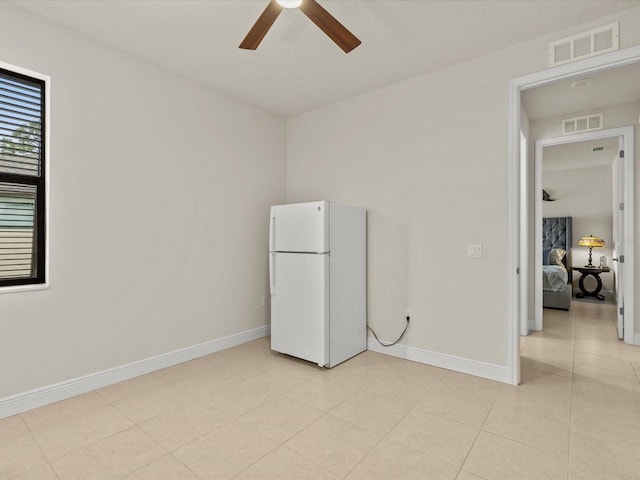 spare room with light tile patterned flooring and ceiling fan