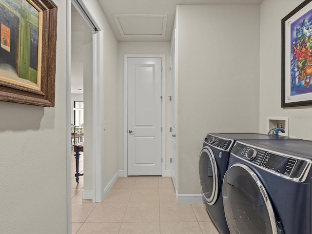 washroom with washing machine and dryer and light tile patterned floors