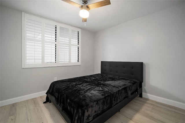 bedroom with ceiling fan and light hardwood / wood-style floors