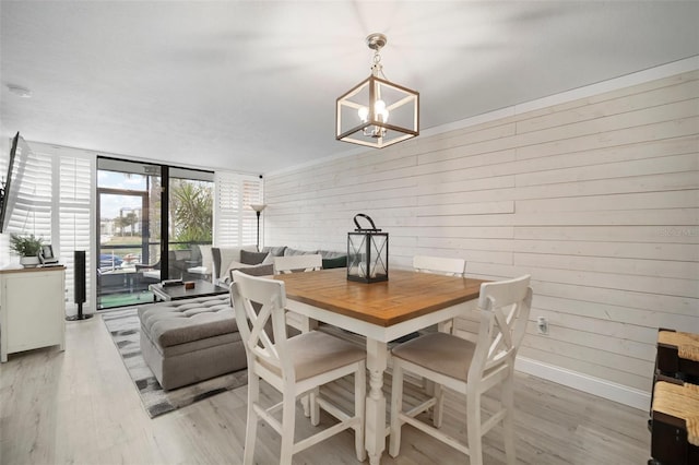 dining space with a chandelier and light wood-type flooring