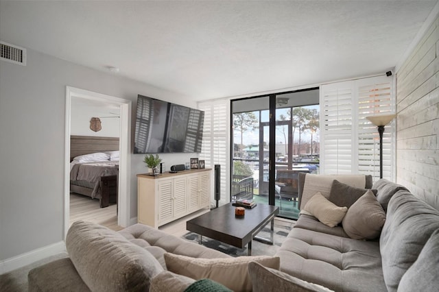 living room featuring a wall of windows