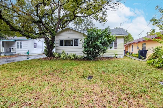 rear view of house featuring a yard