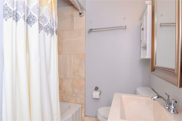 full bathroom featuring toilet, sink, and shower / bath combo with shower curtain