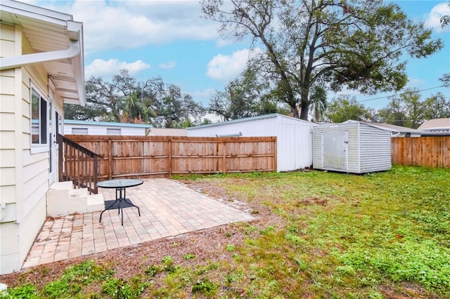 view of yard featuring a storage shed and a patio