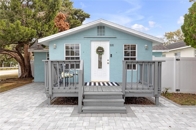 bungalow-style house with a wooden deck