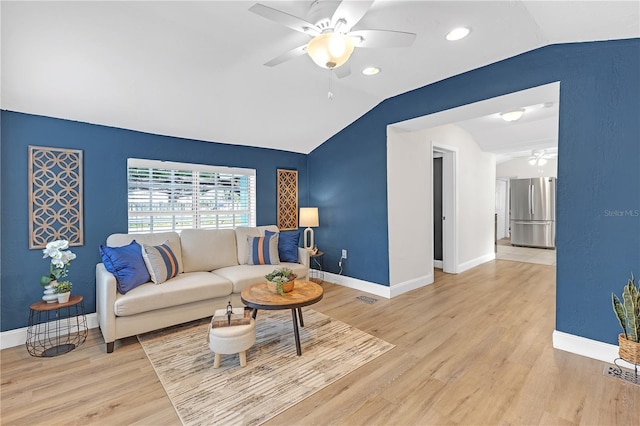 living room featuring vaulted ceiling and light wood-type flooring