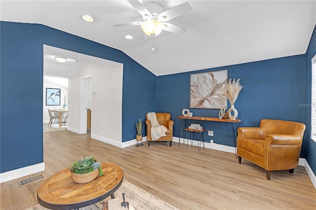 sitting room with ceiling fan, lofted ceiling, and hardwood / wood-style floors