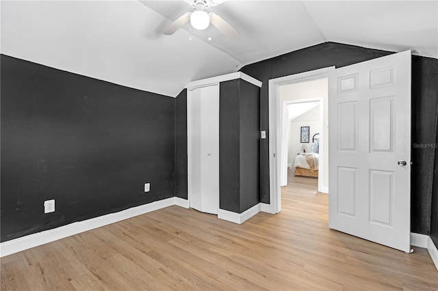 interior space with vaulted ceiling, ceiling fan, and light hardwood / wood-style flooring