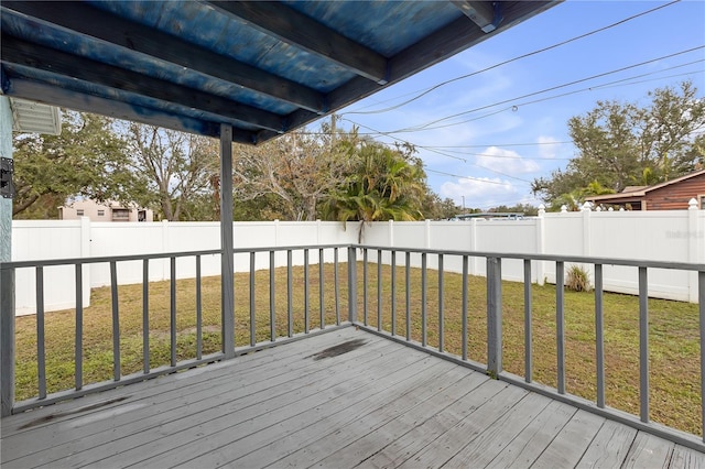 wooden terrace featuring a yard