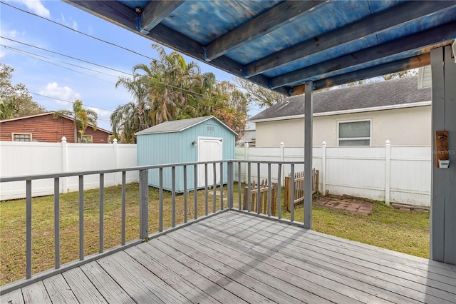 deck featuring a lawn and a storage shed